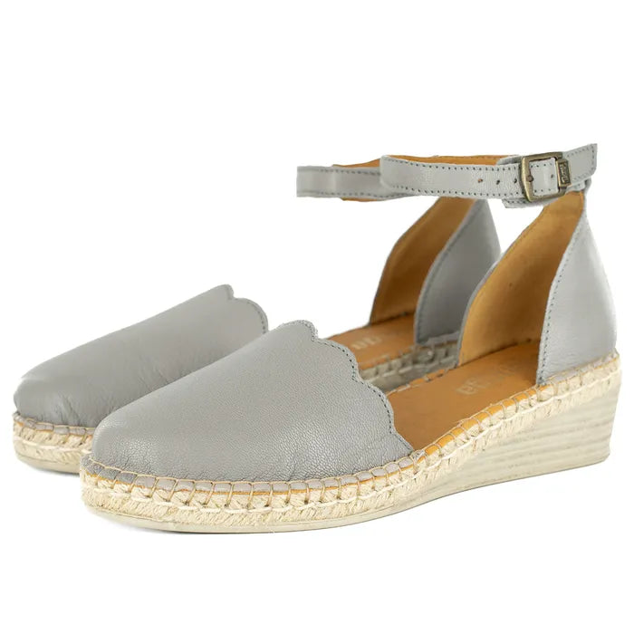 Pair of grey wedge sandals with espadrille sole on a white background