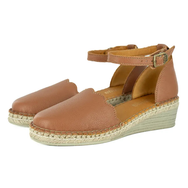 Pair of brown wedge sandals with espadrille sole on a white background