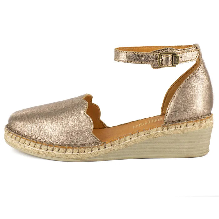 Gold wedge sandal with espadrille sole on a white background