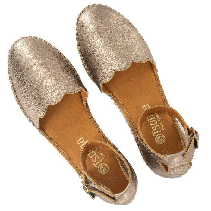 Pair of gold espadrilles with a visible brand logo on a white background