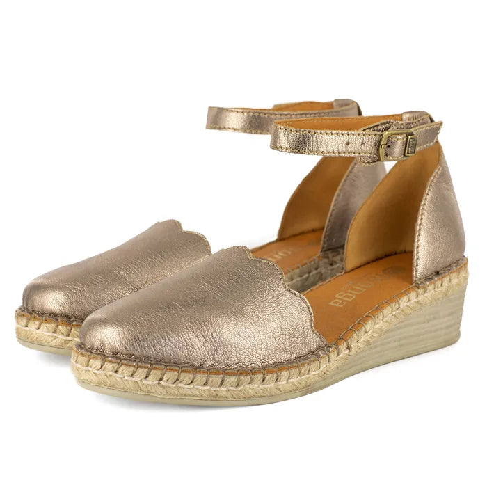 Gold espadrille wedge sandals on a white background