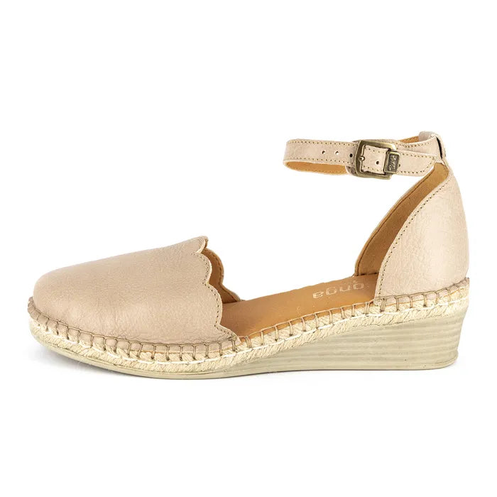 Beige wedge sandal with scalloped edge on a white background