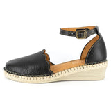 Black wedge sandal with tan sole on a white background