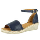 Navy blue wedge sandal with open toe and espadrille sole on a white background