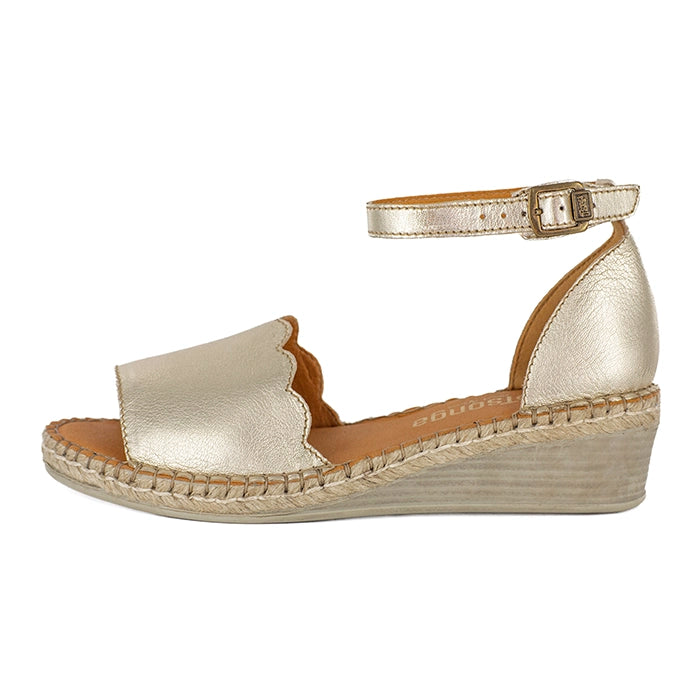Gold wedge sandal with espadrille sole on a white background