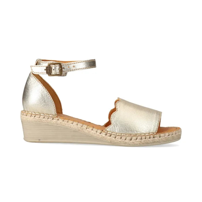 Gold wedge sandal on a white background