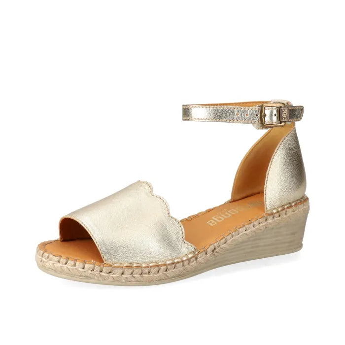 Gold wedge sandal with open toe and espadrille sole on a white background