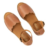 Tan wedge sandal on a white background.