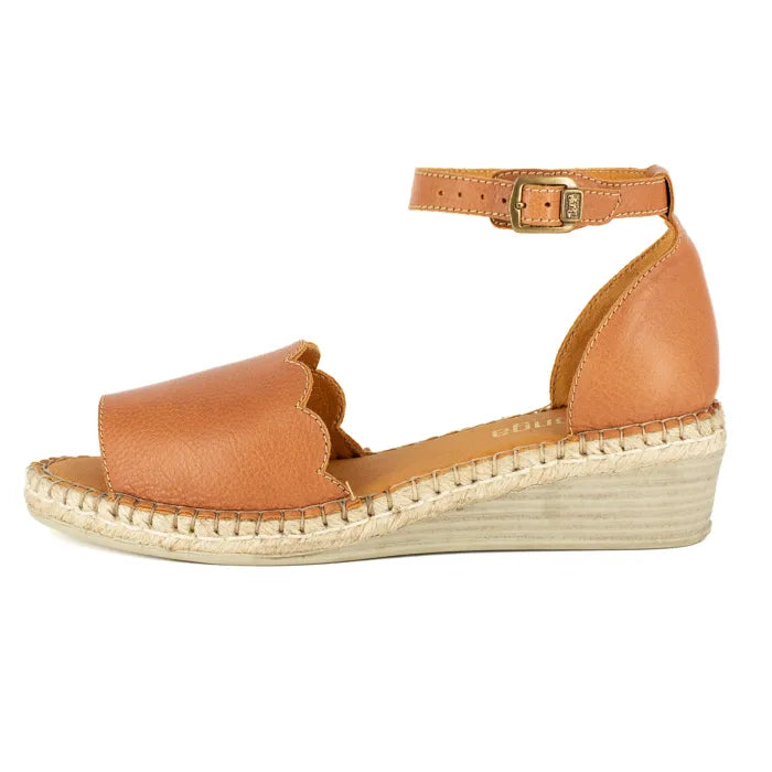Tan wedge sandal with espadrille sole on a white background