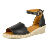 Black wedge sandal with espadrille sole on a white background