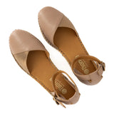 Pair of beige sandals with a brand logo on a white background