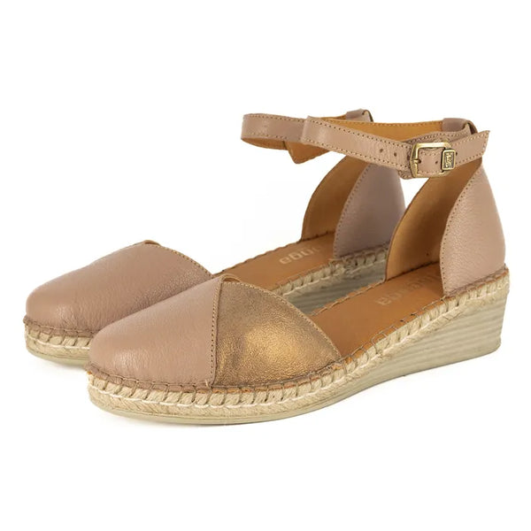 Pair of tan wedge sandals with espadrille sole on a white background