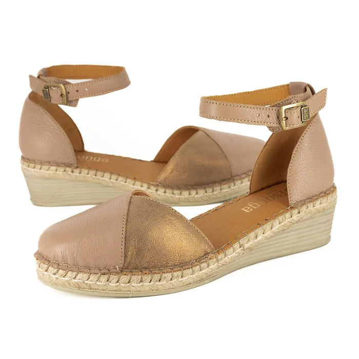 Pair of beige wedge sandals with espadrille sole on a white background