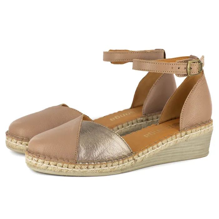 Pair of beige and gold wedge sandals on a white background