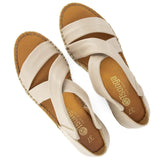 Pair of beige sandals with white straps on a white background