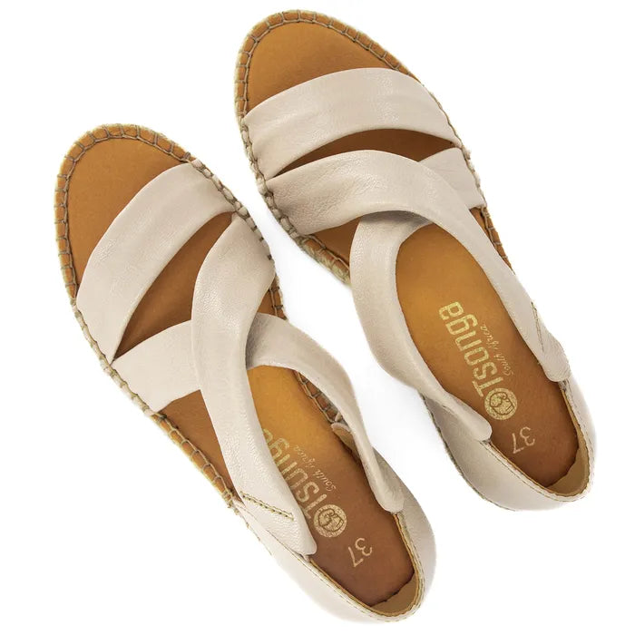 Pair of beige sandals with white straps on a white background