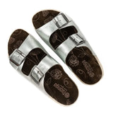 Pair of silver sandals with silver buckles on a white background