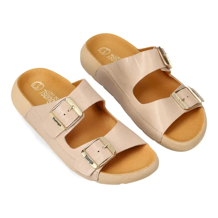 A pair of women's double-strap slide sandals in a light beige leather with gold-tone metal buckles and a tan footbed, shown on a plain white background.