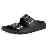 Black sandal with silver buckles on a white background