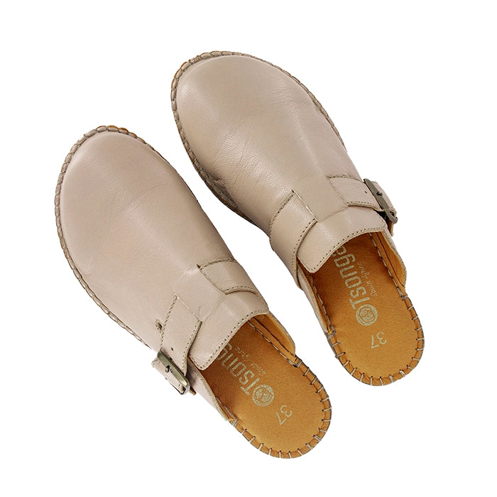 Pair of beige leather mules with buckles on a white background