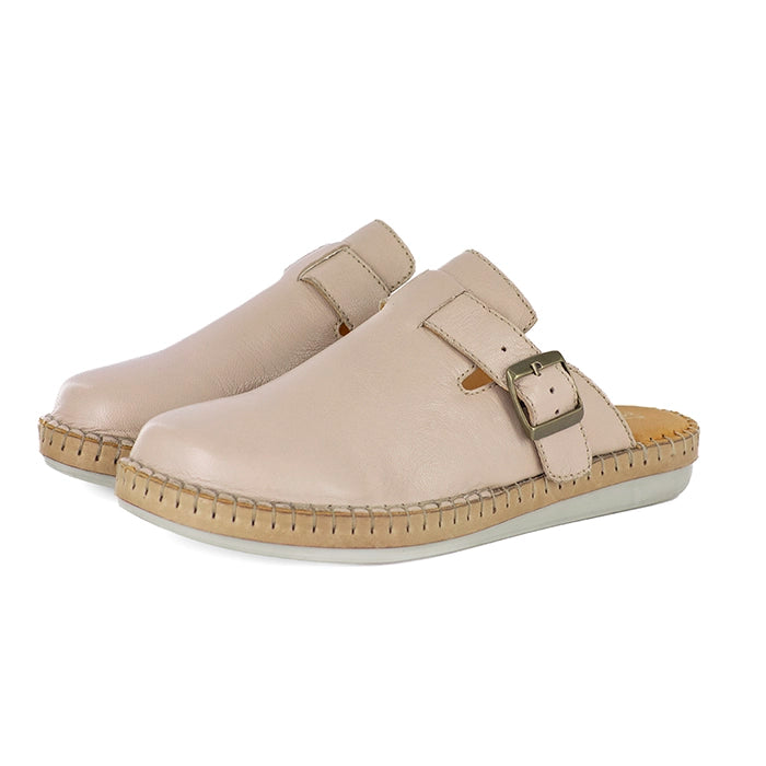 Pair of beige mules with a buckle on a white background