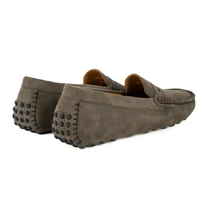 Pair of brown suede loafers on a white background