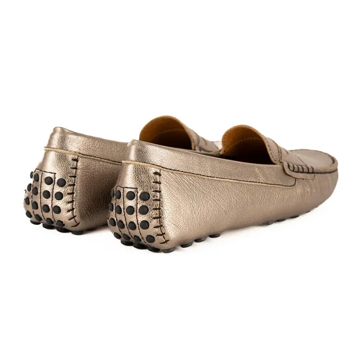Pair of metallic gold loafers with textured sole on a white background
