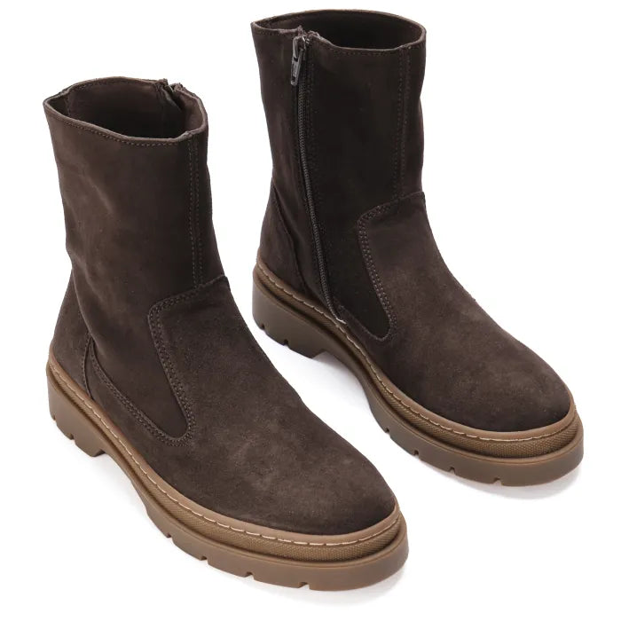 Pair of brown suede boots on a white background