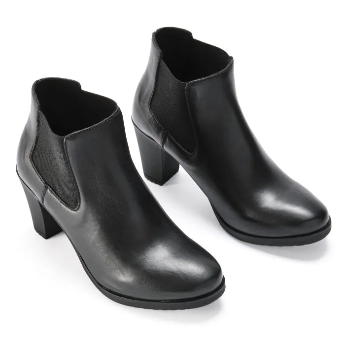 Pair of black ankle boots on a white background