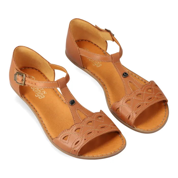 A pair of tan leather flat sandals with cutout details on the toe straps and adjustable ankle straps, displayed on a clean white background.