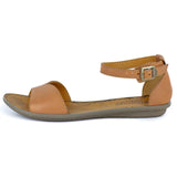Tan sandal with a buckle on a white background