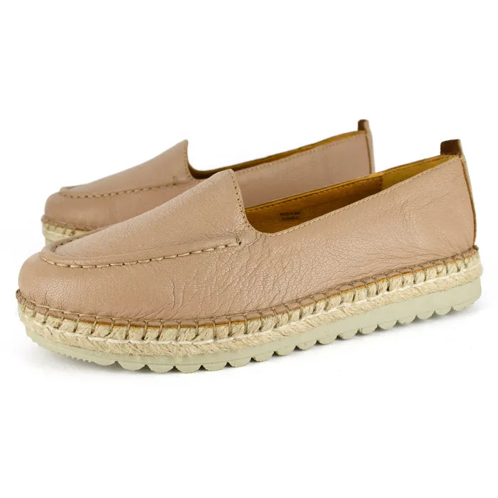 Pair of beige espadrille shoes on a white background