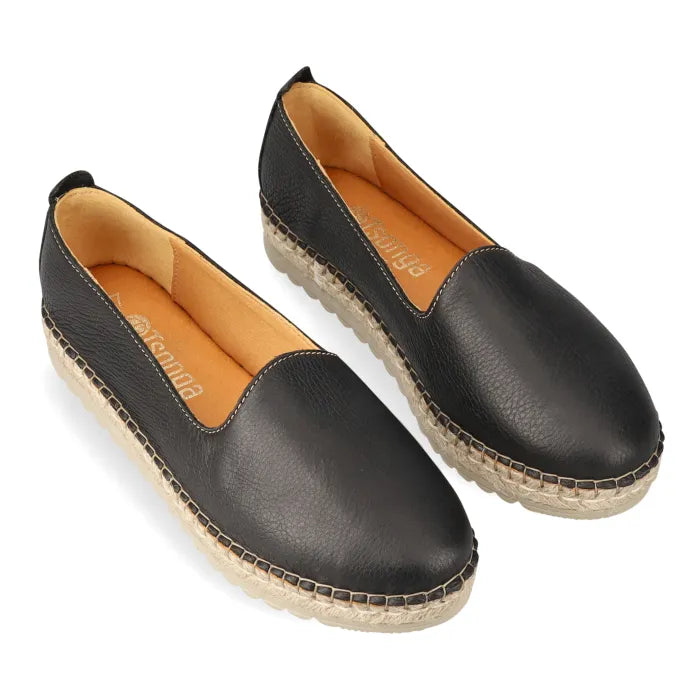 Pair of black espadrilles with jute sole on a white background