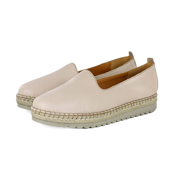 Pair of beige espadrille shoes on a white background