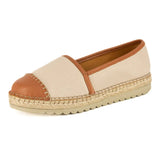 Beige espadrille shoe with brown accents on a white background