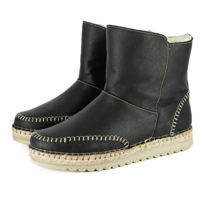 Pair of black leather espadrille boots on a white background