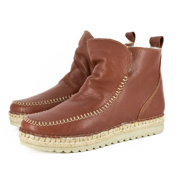 Pair of brown leather espadrille boots on a white background