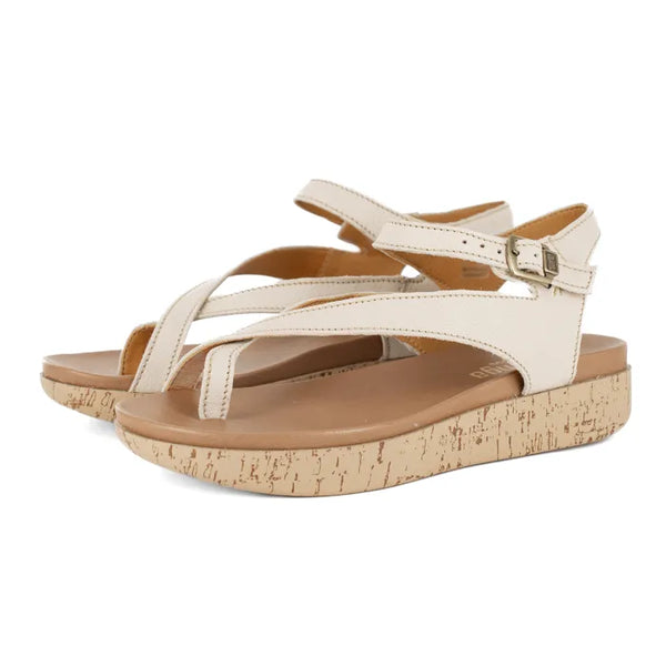 Cream sandals with cork print sole on a white background