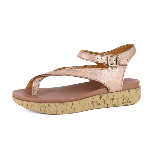 Rose gold sandal with cork print sole on a white background