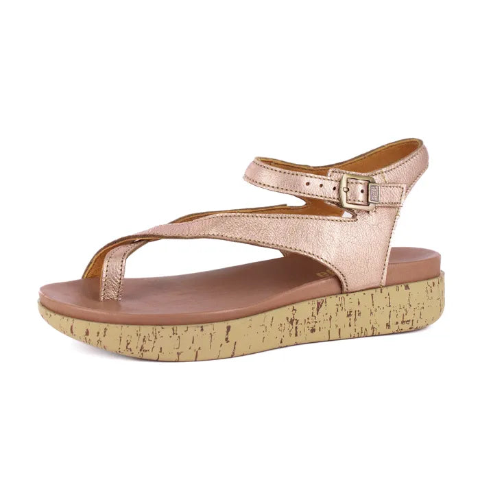Rose gold sandal with cork print sole on a white background