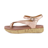 Rose gold sandal with cork print platform on a white background