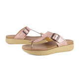 Pair of rose gold sandals with cork print sole on a white background