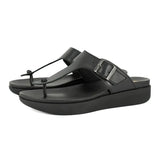 Black sandals with a buckle on a white background