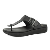 Black sandal with a strap on a white background
