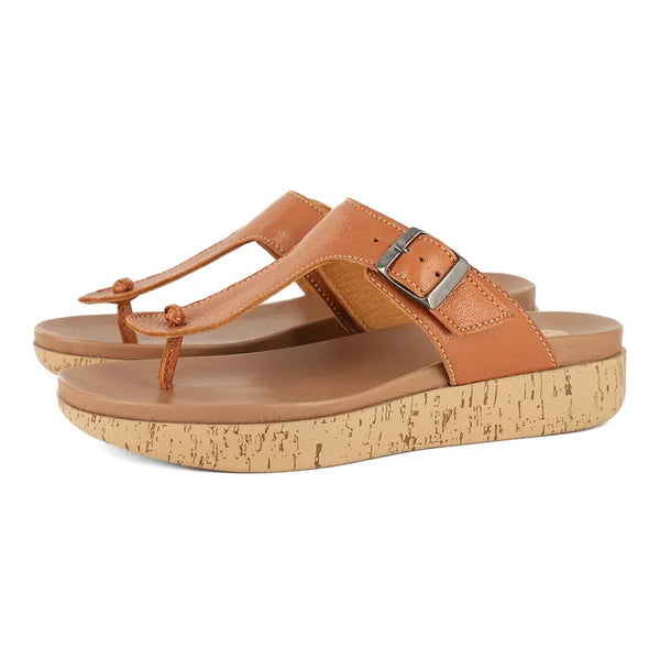 Pair of brown sandals with cork print sole on a white background