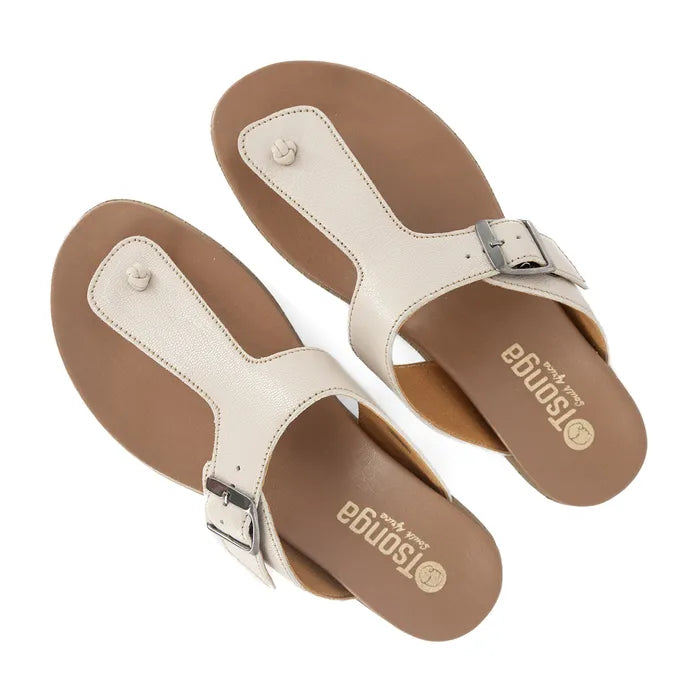 Pair of tan sandals with a buckle on a white background