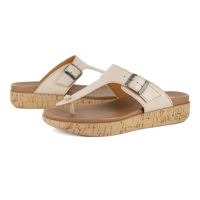 Pair of beige sandals with cork print sole on a white background