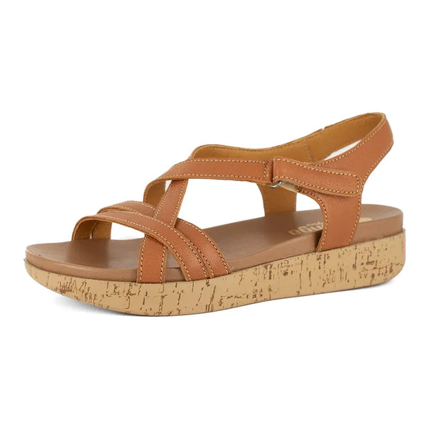 Tan sandal with cork print sole on a white background