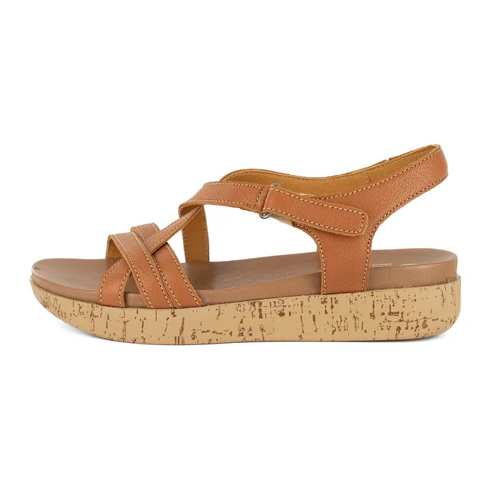 Tan sandal with cork print platform on a white background