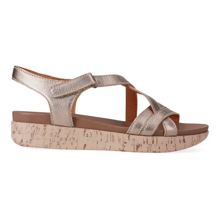 Gold sandal with cork look platform on a white background